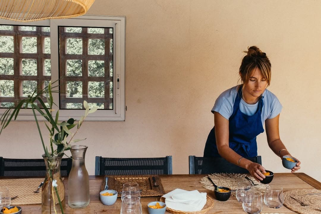 Host preparing a dining table for guests